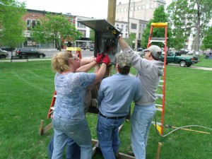 (left to right) Kim Follmeyer, Herb Bluedorn and Tim Cibella work on installing power to Courthouse Square in advance of this weekend's Relay for Life event.