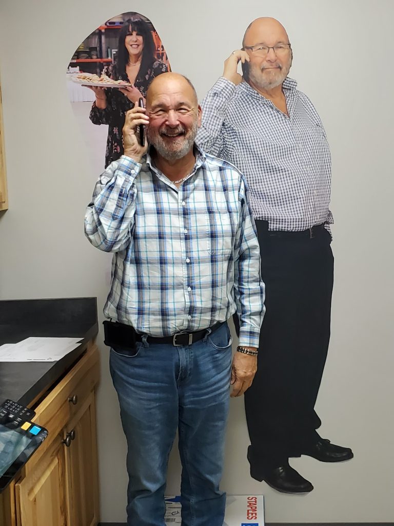 Marc Rubin stands with a large wall sticker of himself.