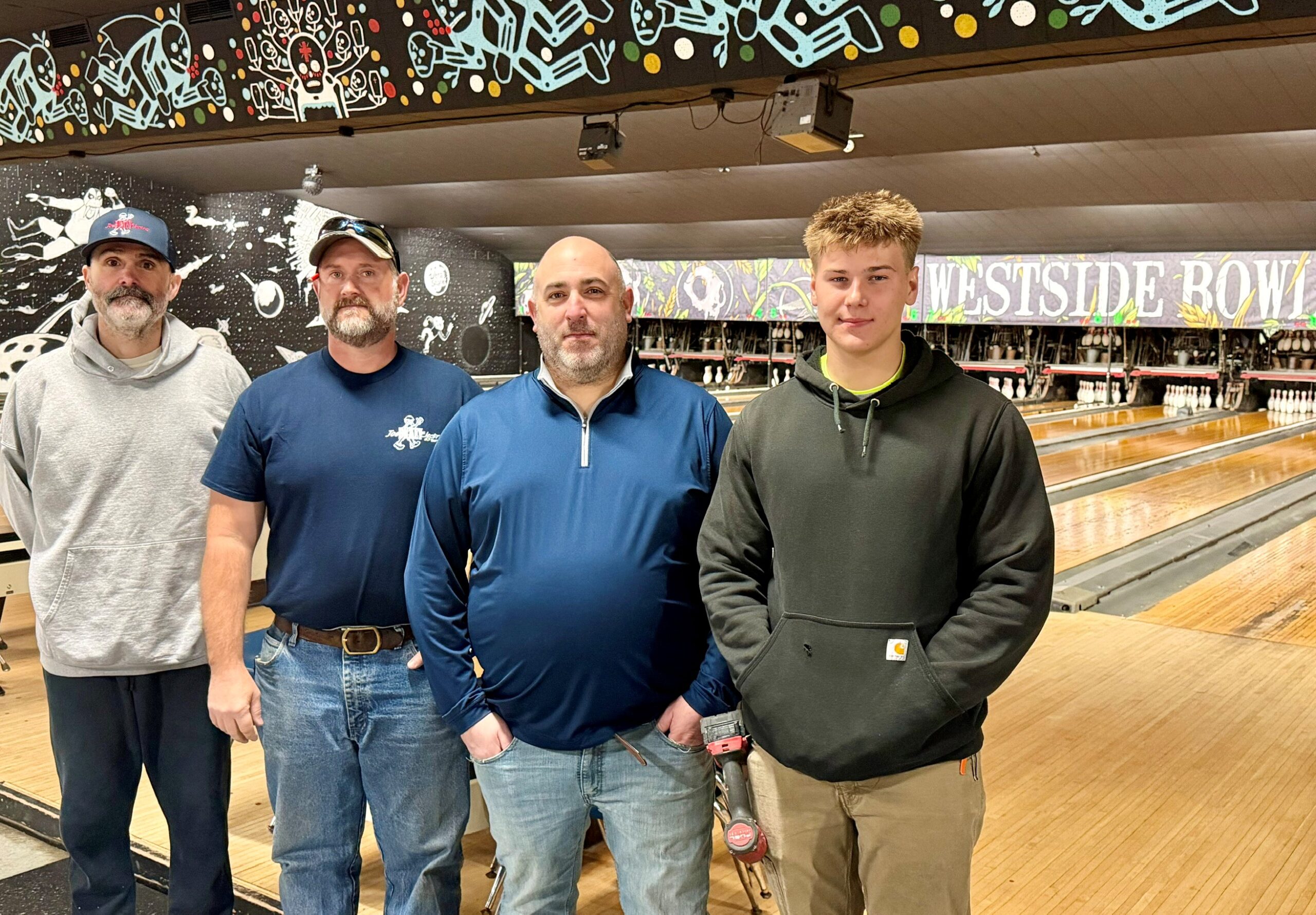 Jon Herchik, Ray Boila and Owen Elliot, of Dickey Electric, with Nathan Offerdahl, owner of Westside Bowl in Youngstown.