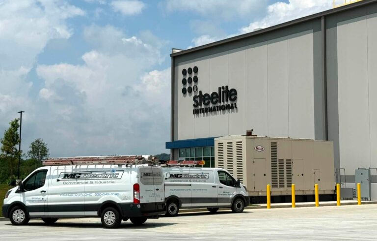 Outside of Steelite warehouse building in New Castle with MG Electric trucks.
