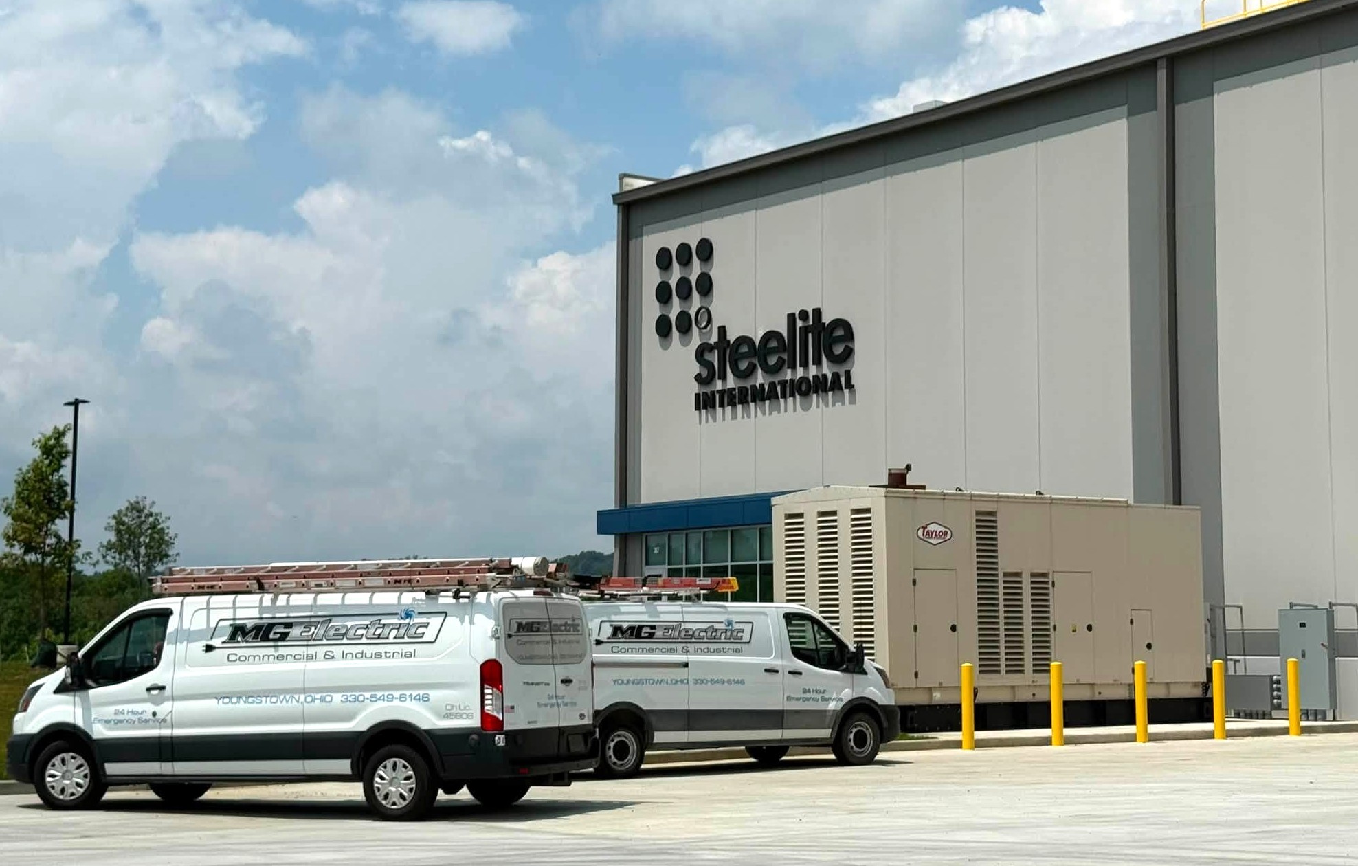 Outside of Steelite warehouse building in New Castle with MG Electric trucks.