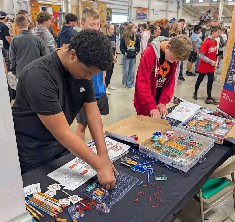 Students working on the circuit board activity at the electrical station at the Mahoning Valley Skilled Trades Expo.