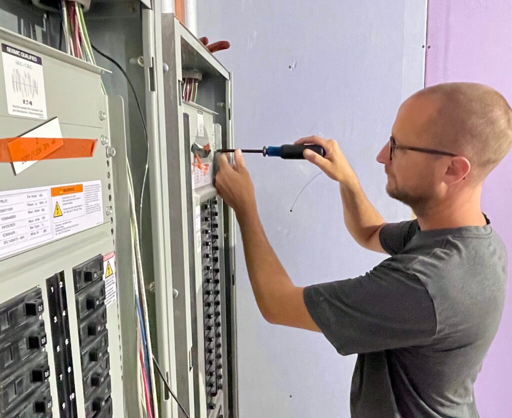 Eric Krestel, foreman at MG Electric, checking new distribution panels inside the building.