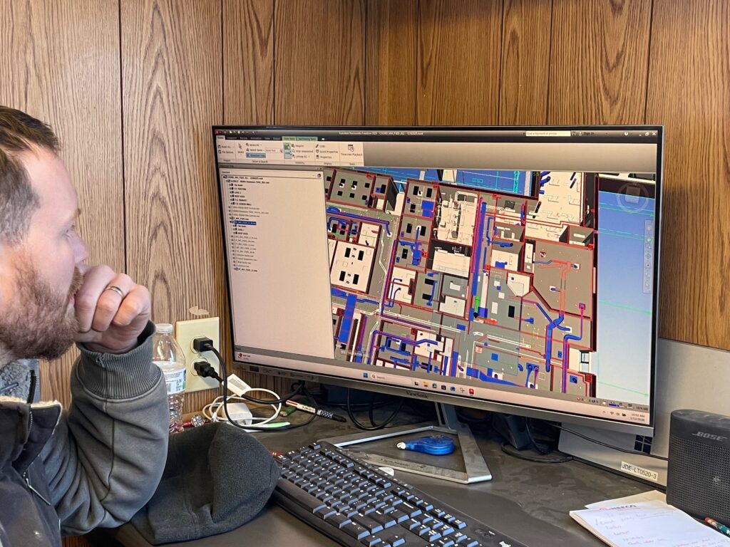 Chris Pearce, of Dickey Electric, looking at 3D model of plans for the building.