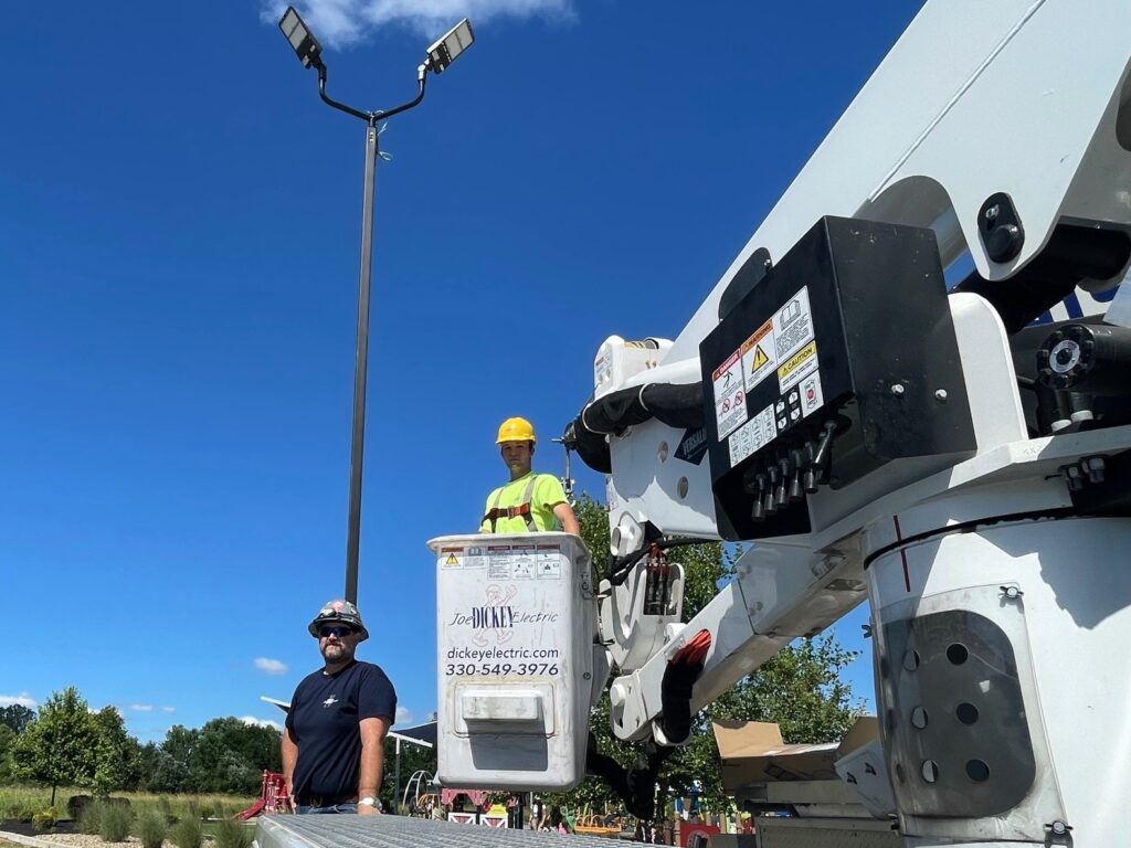 John Herchik and Anthony Petrella, of Dickey Electric, at The Walnut Grove light pole.