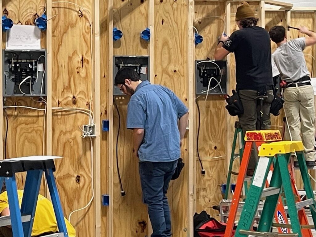 Students working on the residential wiring project for the SkillsUSA competition at IBEW Local 64.