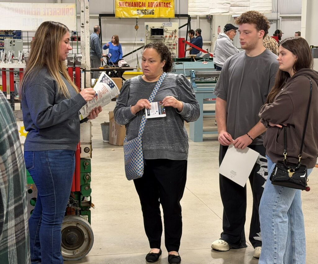 Grace Morrison, IBEW Local 573 journeyman, talking with family about electrical trade opportunities.
