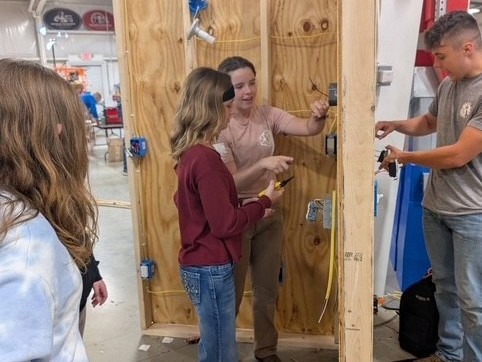 Peyton Flower, apprentice, shows student residential wiring process at Mahoning Valley Skilled Trades Expo.
