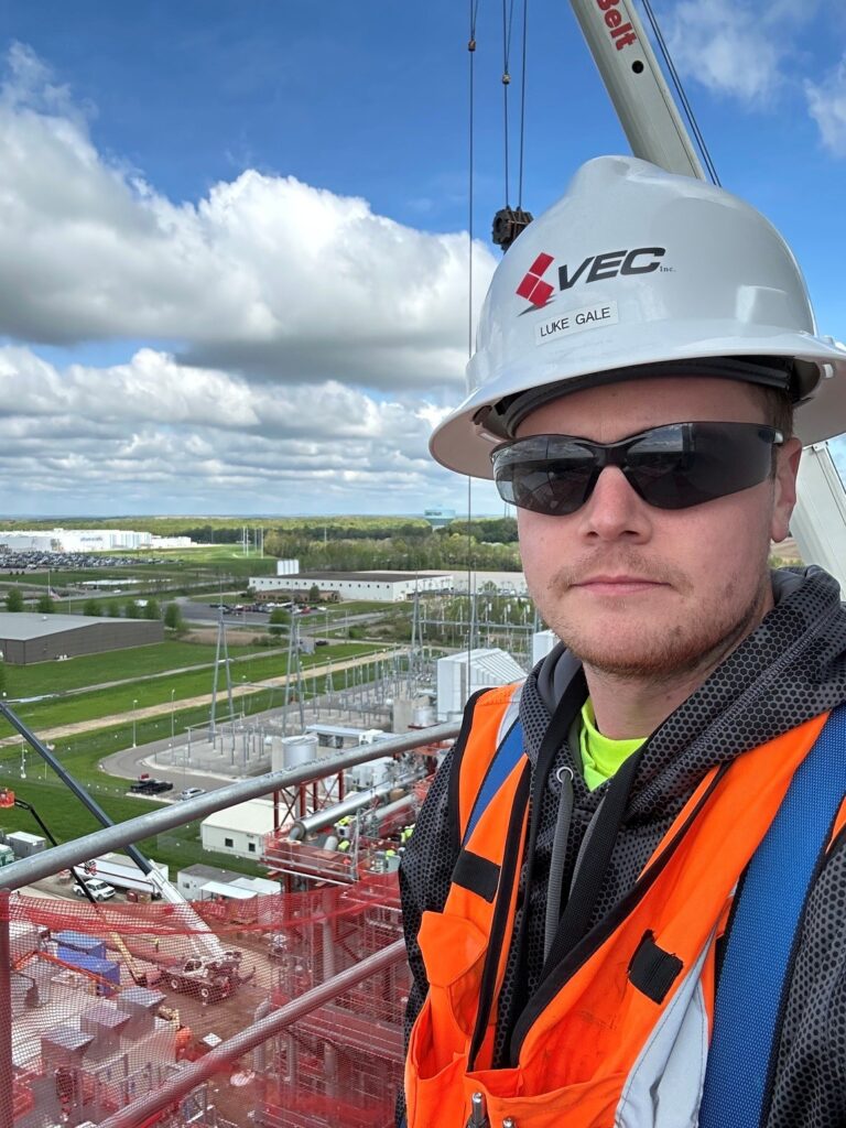 Luke Gale on the powerhouse smokestack across from the Ultium Cells plant in Lordstown.