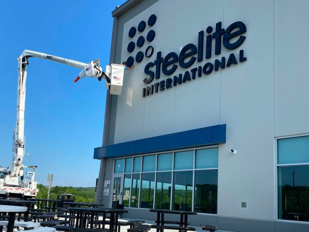 MG Electric in bucket truck putting finishing touches on the signage lighting for Steelite warehouse.
