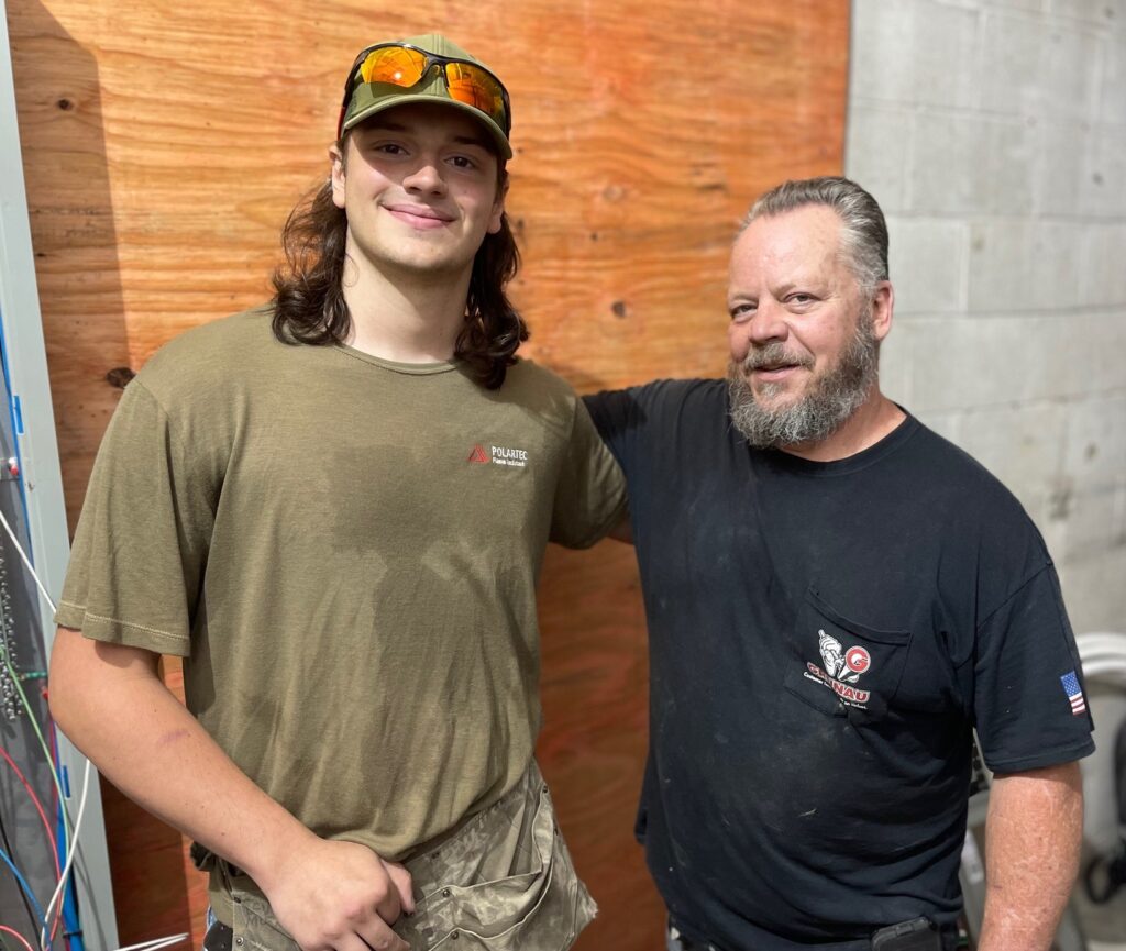 Isaac Arnold, apprentice with MG Electric, with journeyman Bob Mass. He was also Arnold's instructor at the Youngstown JATC.