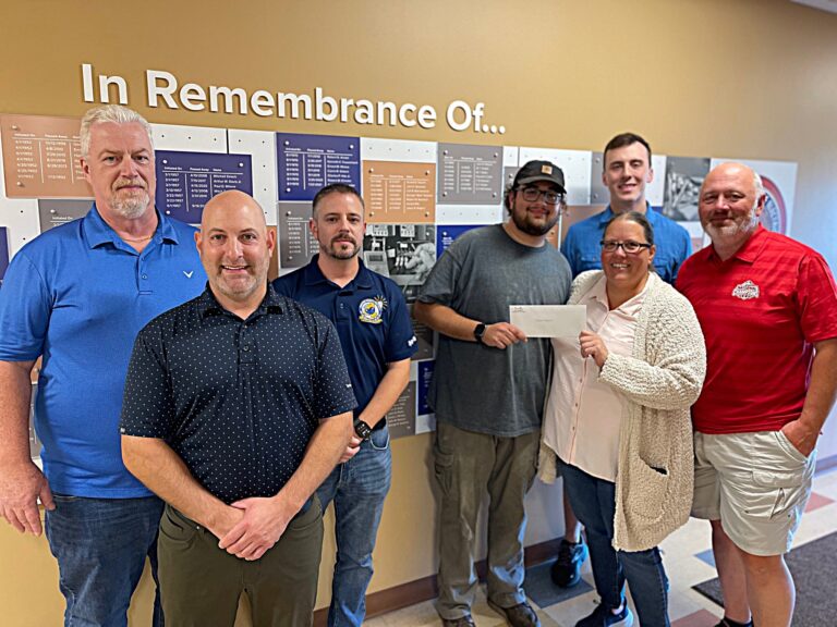IBEW Local 573 leadership (Eric Davis, Warren JATC training director; Todd Ambrose, IBEW Local 573 business manager; Mark Phillips, IBEW Local 573 president/organizer) with Mike Ferradino, second-year apprentice, and scholarship recipient, and Amy, Matt and Jacob Connelly.
