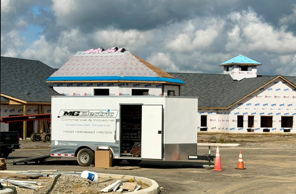 MG Electric trailer outside the assisted living building for Shepherd of the Valley - where electrical contractors are working at the property.