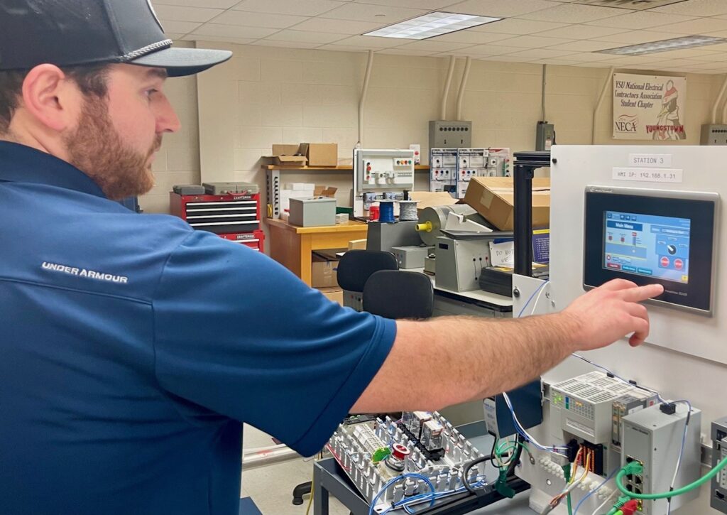 Alex Birtalan, of Dickey Electric, showing the operations for his senior capstone project. He's in the electrical industry and will now have a degree in electrical engineering technology.