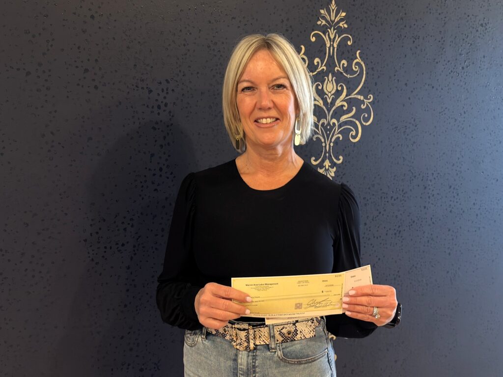 Amy Shope, founder of Dylan's House, with Youngstown and Warren LMCC checks totaling $500.