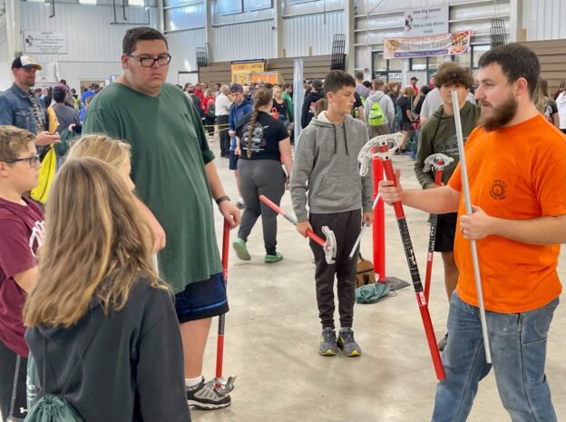 Nate Castle, IBEW Local 573, explains conduit bending to students at the MVST Expo in Canfield.