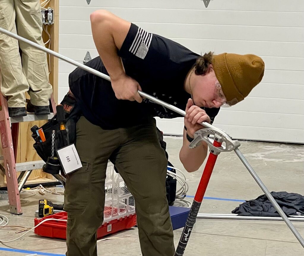 Connor Jones, senior at MCCTC, bending conduit for the residential wiring project.