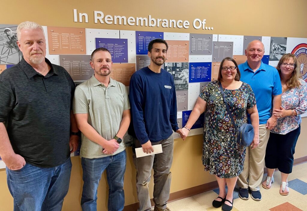 Warren JATC training director Eric Davis and IBEW Local 573 president/organizer Mark Phillips with the Connelly family and Austin Claussell.