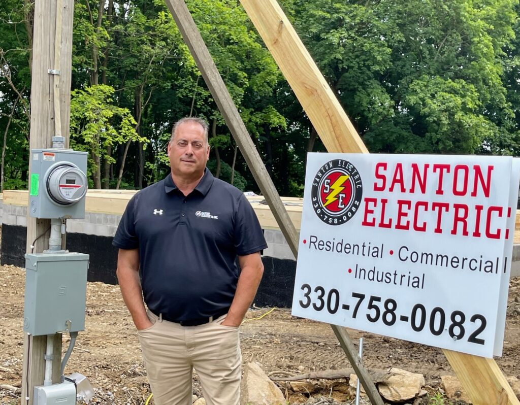 Frank Sferra, of Santon Electric, outside of foundation for residential housing on Bernard Street in Youngstown.