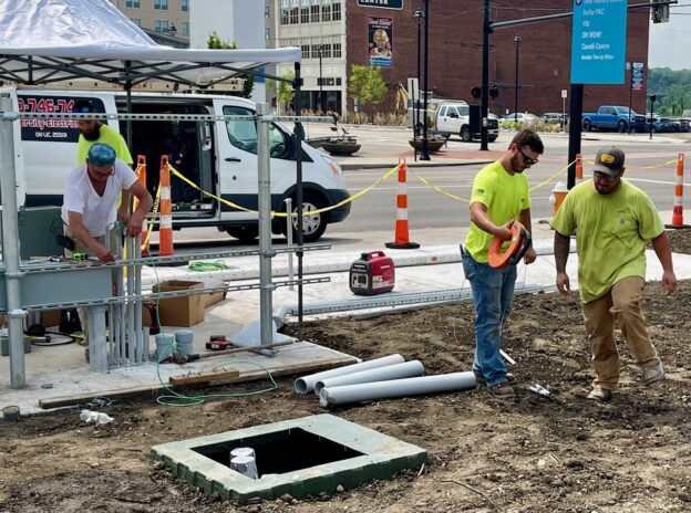 University Electric crew working on wiring for EV chargers that will go in the parking lot on Fifth Avenue and Martin Luther King Boulevard in Youngstown.