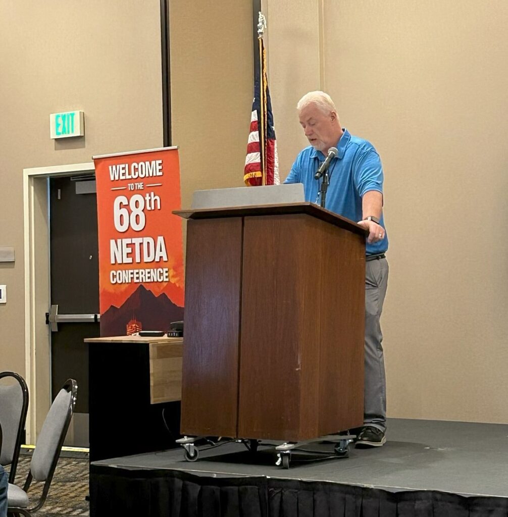 Eric Davis speaking for retiring leaders at the NETDA Conference in Denver about carrying the work forward.