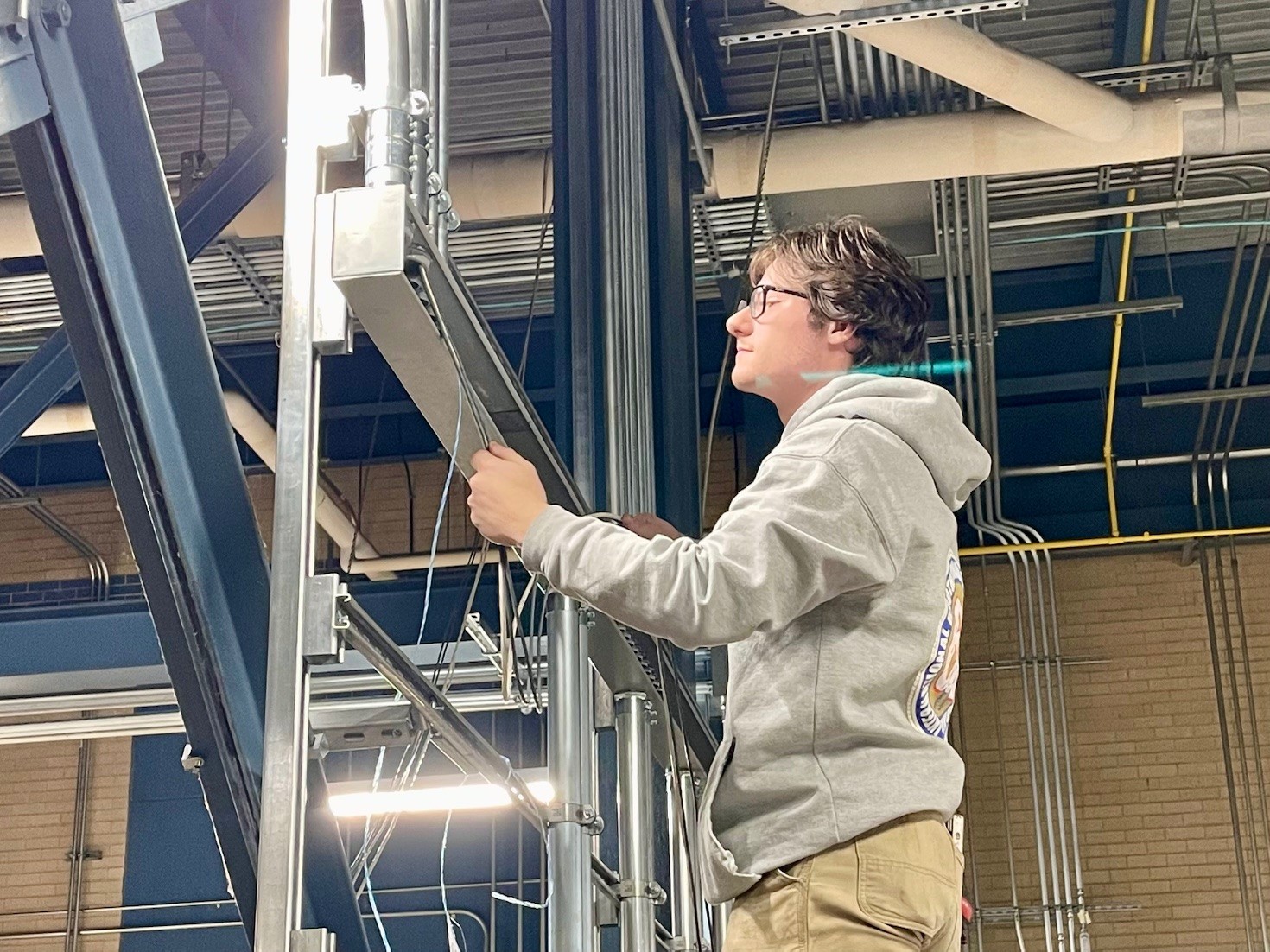 Ivan Lindberg, IBEW Local 64 first-year apprentice, working at Mercy Health St. E's chiller plant project.