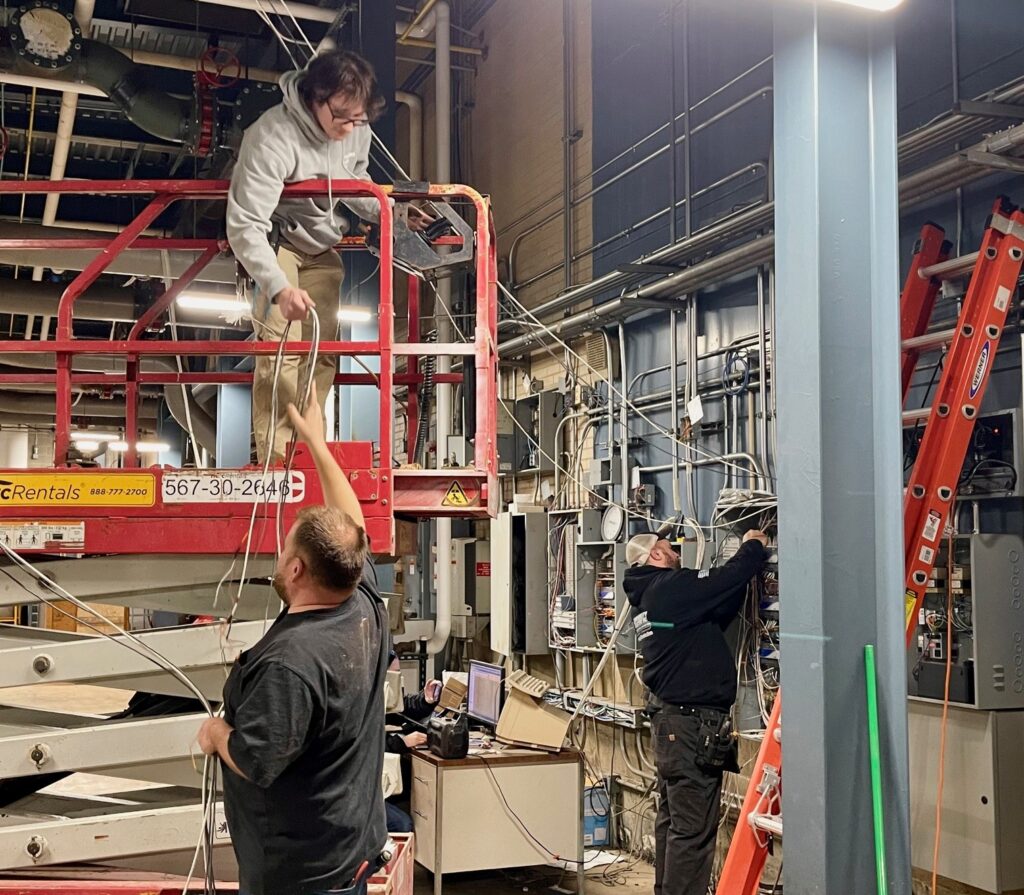 Brad Kollar and Ivan Lindberg preparing wiring for the overhead work at the hospital chiller plant in downtown Youngstown.