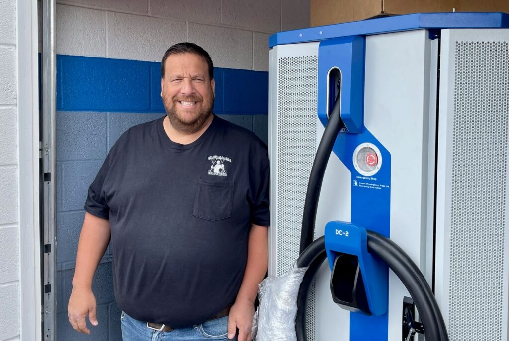 Jason Rubin with EV charger at Greenwood Chevy in Austintown