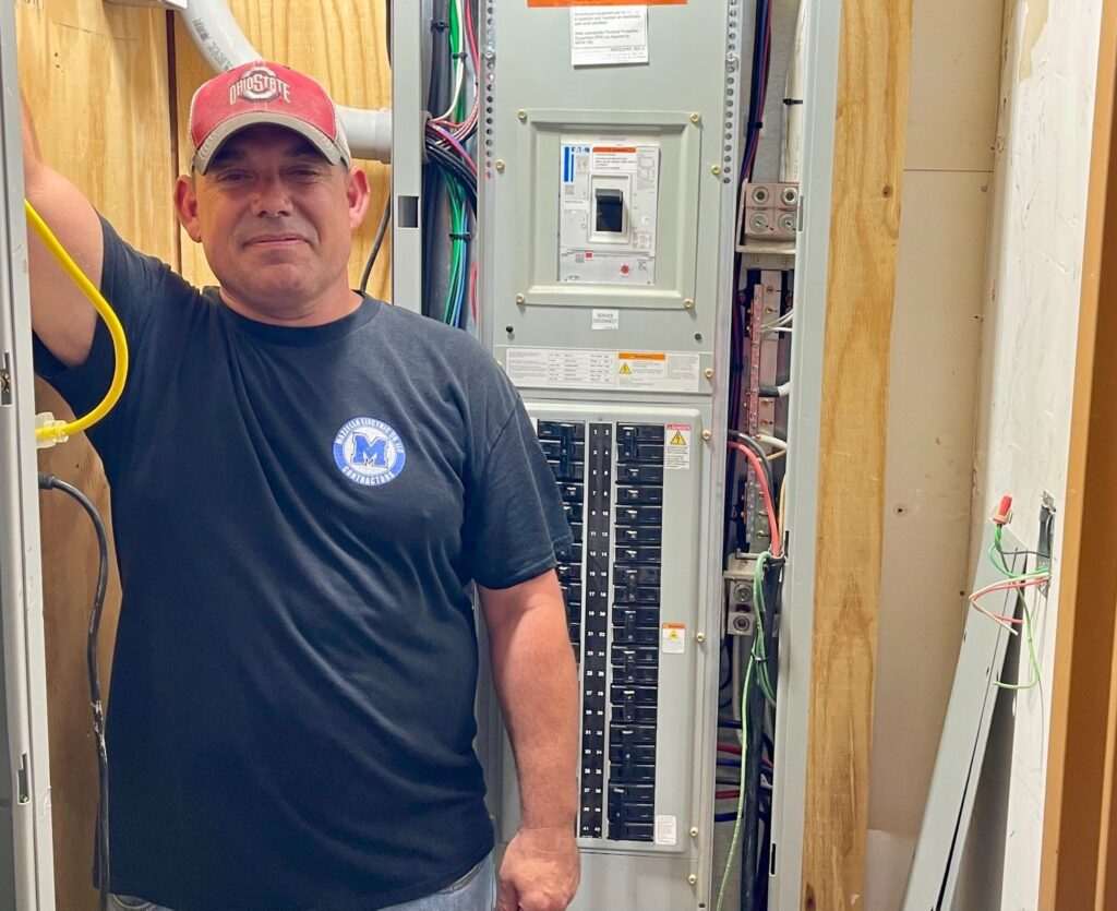 Joe McGath, of Mazzella Electric, standing with main panel at Ebert Animal Hospital in Boardman