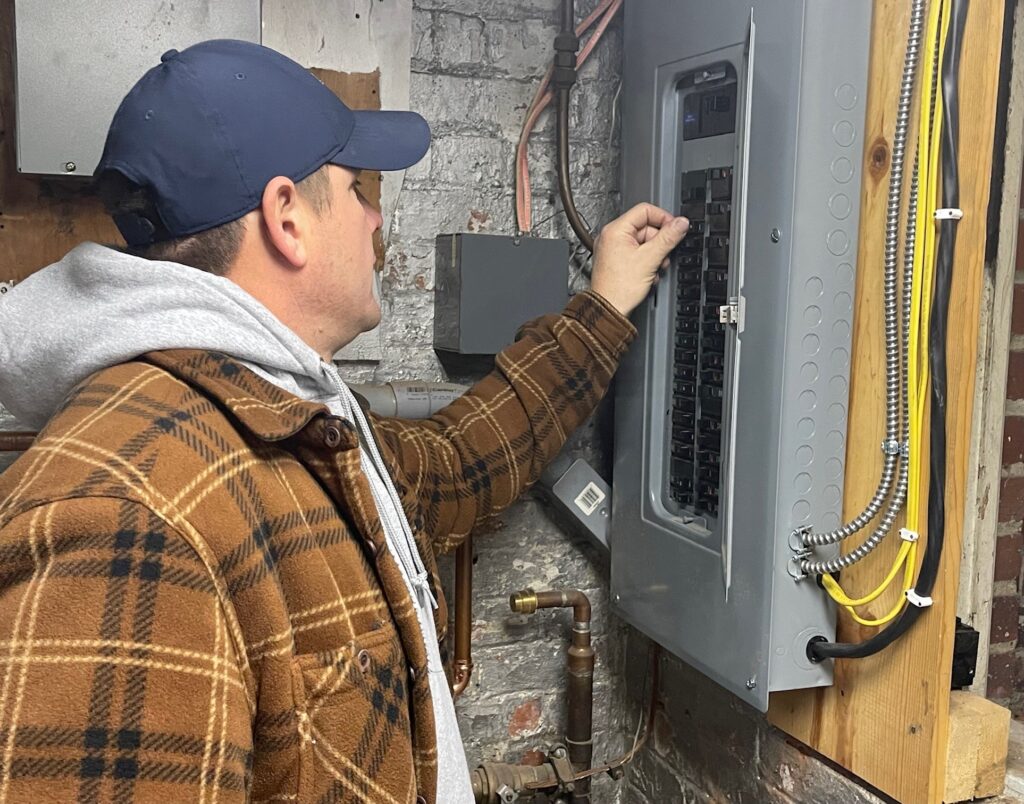 Kurt Eisenbraun, project manager at Dickey Electric, at new electrical panel.