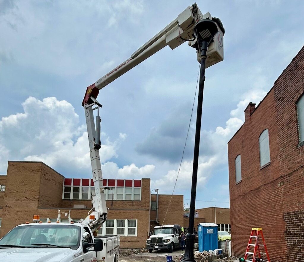 Setting light pole for the EV charger parking lot in Youngstown.