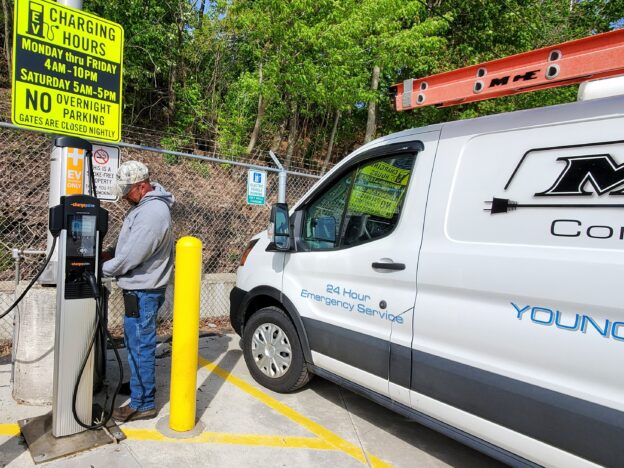 Chuck Wright, journeyman electrician with MG Electric, checks one of the three charging stations at WRTA in Youngstown.