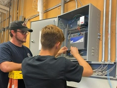 Ahren Peplow with an electrician apprentice at a job sometime in 2022.