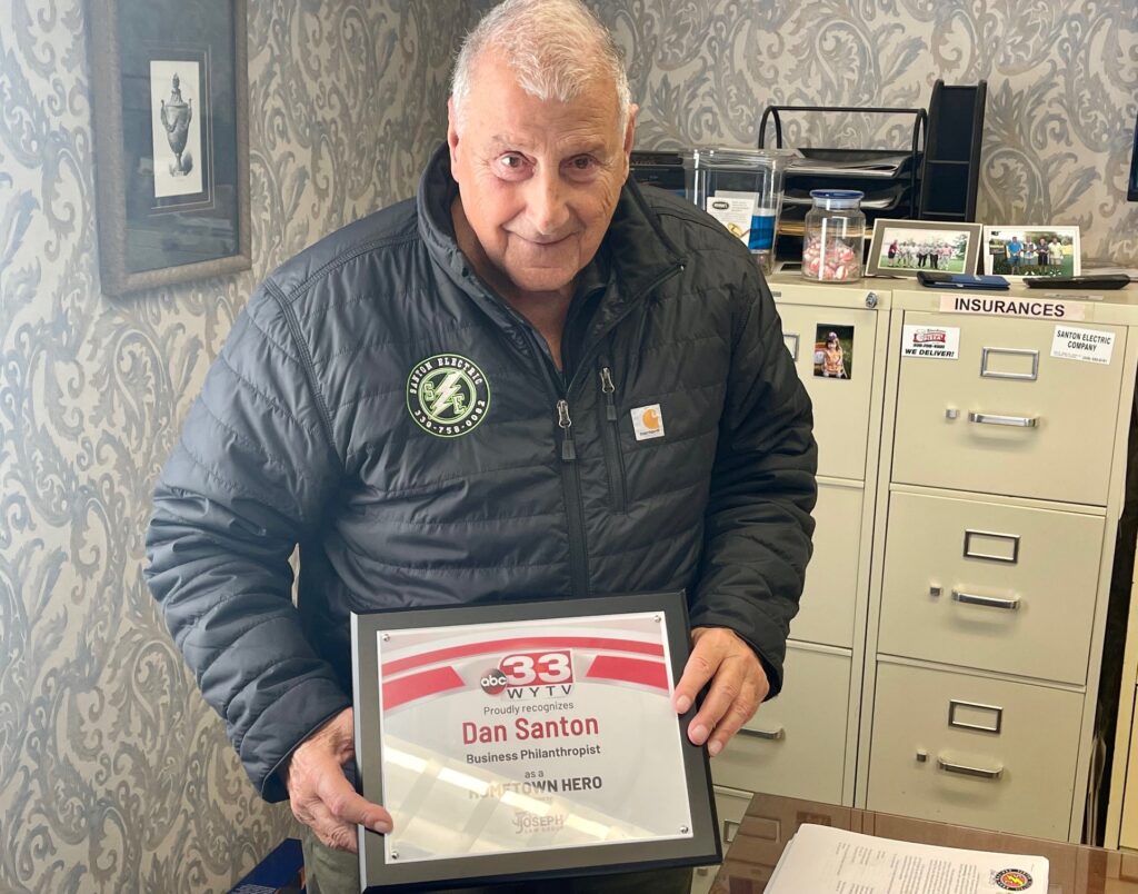 Dan Santon, owner of Santon Electric, with his WYTV Hometown Hero plaque in his office in Boardman.