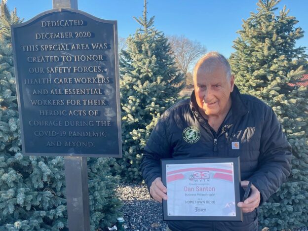 Dan Santon, owner of Santon Electric in Boardman, stands with his WYTV Hometown Hero plaque at his memorial outside the company for military members, health care workers, police and fire departments.