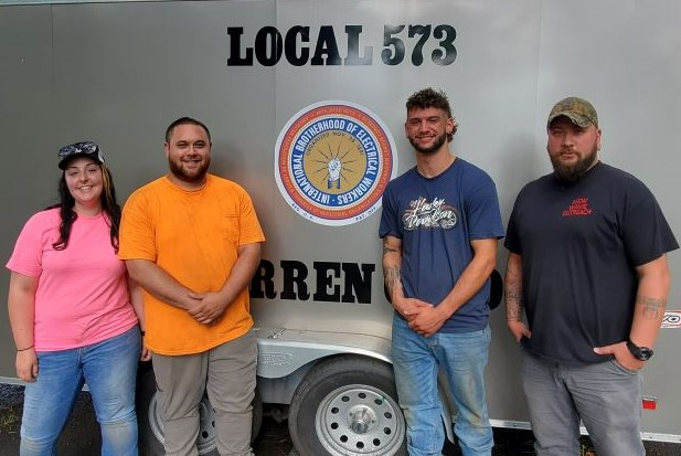 Local 573 volunteer stand with their logo.