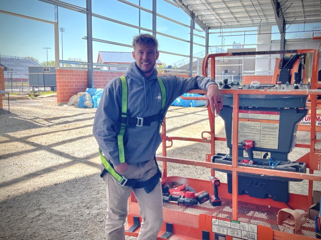 Tom Plummer, an electrician apprentice with IBEW Local 64, standing in the construction of Austintown Fitch indoor training facility.