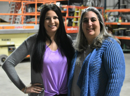 Nikki Copenhaver and Sheila Danko stand in warehouse.