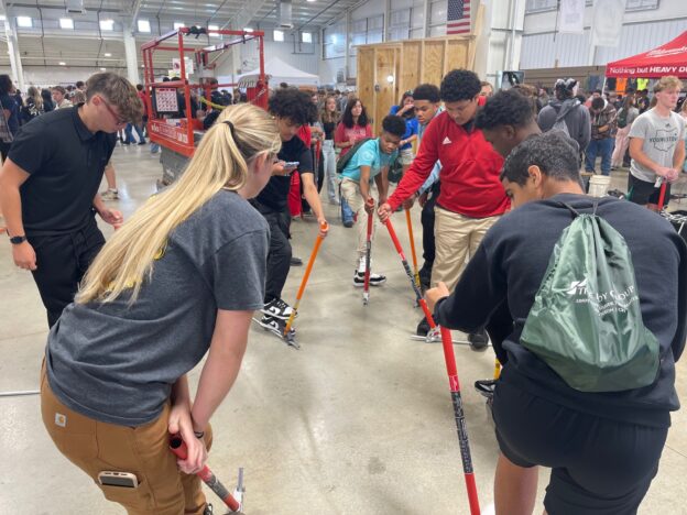 Apprentice shows students how to bend conduit at Mahoning Valley Skilled Trades Expo